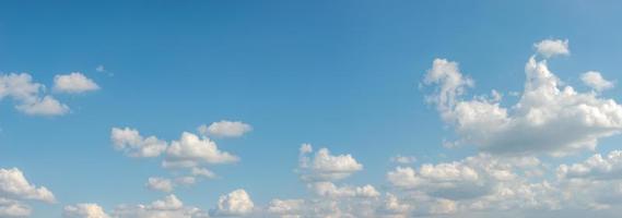 Banner with panoramic view over deep blue clean sky with illuminated clouds as a background. photo