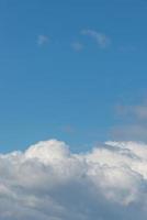 Cover page with soft blue sky with illuminated clouds as a background. photo