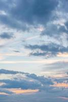 Cover page with deep blue sky with illuminated clouds at soft orange sunset as a background. photo