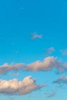 Cover page with soft blue sky with illuminated clouds as a background. photo