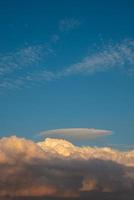 Cover page with gradient soft deep orange sky, illuminated clouds at bloody sunset as a background. photo