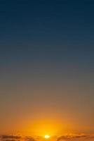 Cover page with gradient soft deep orange sky, illuminated clouds at bloody sunset as a background. photo