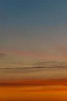 Cover page with gradient soft deep orange sky, illuminated clouds at bloody sunset as a background. photo