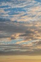 Cover page with gradient soft deep orange sky, illuminated clouds at bloody sunset as a background. photo