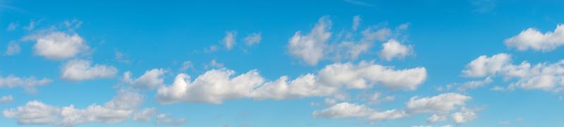 Banner with panoramic view over deep blue clean sky with illuminated clouds as a background. photo