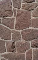 Pattern of ancient bricks and stones at old middle age fortress wall, as a background, closeup, details. photo