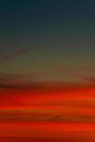 Cover page with gradient soft deep orange sky, illuminated clouds at bloody sunset as a background. photo