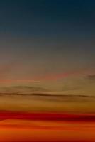 Cover page with gradient deep orange sky, illuminated clouds at bloody sunset as a background. photo