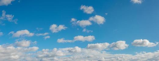 Panoramic view over blue deep sky with clouds as a background with copy space. photo