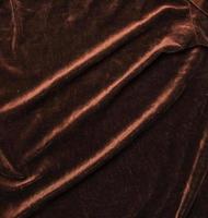 Background of brown velor fabric. Modern upholstered velvet furniture. Creative vintage background. photo