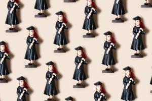 Class of 2023 concept. Wooden number 2023 with graduate statuette on color background photo