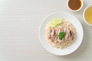 Hainanese Chicken Rice or steamed rice with chicken photo