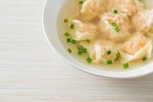 shrimp dumpling soup in white bowl photo