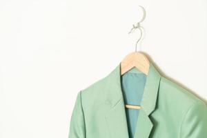 green suit hanging with wood hanger photo