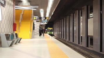 Underground train stops at a platform and passengers embark and disembark, noise effect, selective focus video