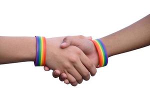 Isolated hands which wear rainbow wristband around them with clipping paths. photo