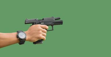 Isolated 9mm pistol gun holding in right hand of gun shooter with clipping paths. photo