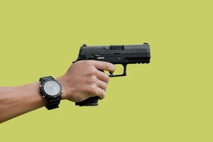 Isolated 9mm pistol gun holding in right hand of gun shooter with clipping paths. photo