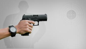 Isolated 9mm pistol gun holding in right hand of gun shooter with clipping paths. photo