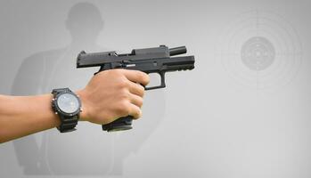 Isolated 9mm pistol gun holding in right hand of gun shooter with clipping paths. photo