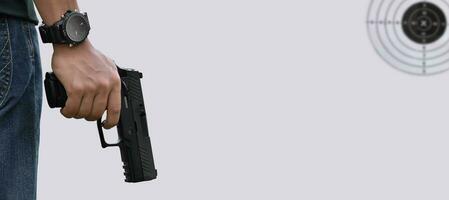 Isolated 9mm pistol gun holding in right hand of gun shooter with clipping paths. photo