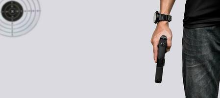 Isolated 9mm pistol gun holding in right hand of gun shooter with clipping paths. photo