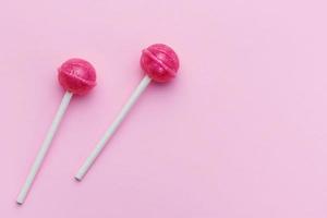 Sweet lollipops on pink background photo