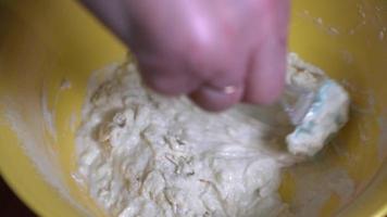 Kneading dough with a silicone spatula in a close-up shot. video