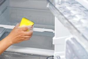 Employees use a cloth to clean the refrigerator. photo