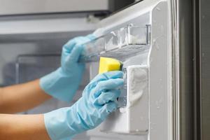 Employees use a cloth to clean the refrigerator. photo