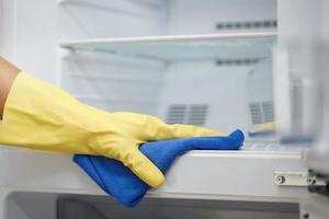 Employees use a cloth to clean the refrigerator. photo