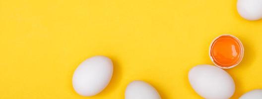 Top view egg yolk and egg white high protein good for body yellow background. photo