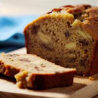 Homemade banana bread on wooden background. Banana Bread Nut Loaf. banana bread loaf that is sliced into with one slice in front. photo