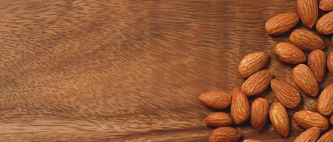 Almonds on a wooden background photo