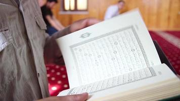 young muslim reading quran in mosque video