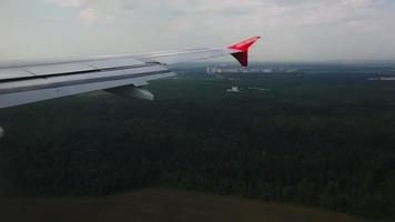 Airplane flight. The wing of an airplane flying over the city. View from the airplane window. Airplane. Air travel video