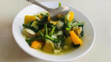 clear vegetable made from a combination of long beans, eggplant, pumpkin, bamboo shoots, and long bean leaves. very delicious served on a rainy video