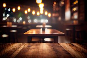 image of wooden table in front of abstract blurred background of resturant lights. Wood table top on blur of lighting in night cafe,restaurant background.selective focus. photo