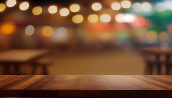 image of wooden table in front of abstract blurred background of resturant lights. Wood table top on blur of lighting in night cafe,restaurant background. selective focus. photo