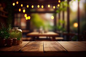 image of wooden table in front of abstract blurred background of resturant lights. Wood table top on blur of lighting in night cafe,restaurant background. selective focus. photo