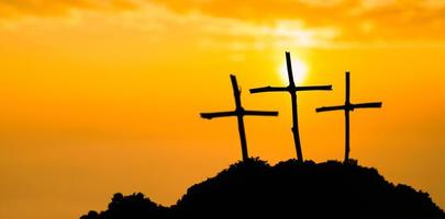 Crucifixion Of Jesus Christ - Cross At Sunset. The concept of the resurrection of Jesus in Christianity. Crucifixion on Calvary or Golgotha hills in holy bible. photo