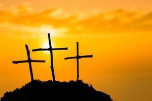 Crucifixion Of Jesus Christ - Cross At Sunset. The concept of the resurrection of Jesus in Christianity. Crucifixion on Calvary or Golgotha hills in holy bible. photo