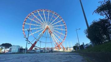 Ferris wheel with blue sky and cloudy background video