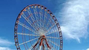 Ferris wheel with blue sky and cloudy background video