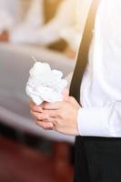 Closed up child hands holding white candle in wedding. photo