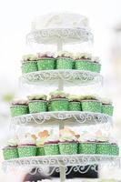 Wedding chocolate Cupcakes in green cup with garland lights bokeh and sunlight background photo