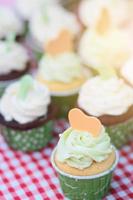 Wedding chocolate Cupcakes in green cup with garland lights bokeh and sunlight background photo