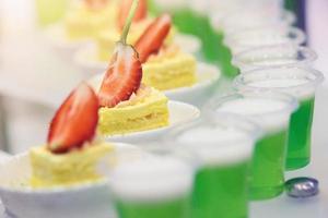 Set of delicious canapes with strawberry and cheesecake photo