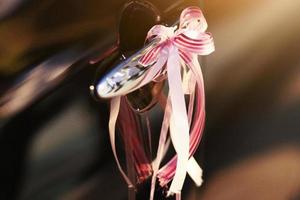 Beautiful Ribbon decorated on black car door handles for wedding photo