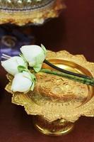 Beautiful pink lily and lotus flowers decoration on gold tray for pray Buddha statue.Thai wedding culture tradition. photo